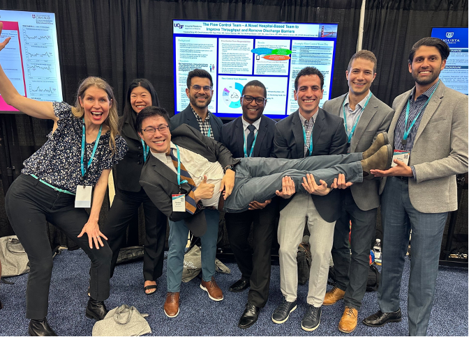 Image of Teddy Peng and colleagues in front of a poster at an SHM Converge conference.